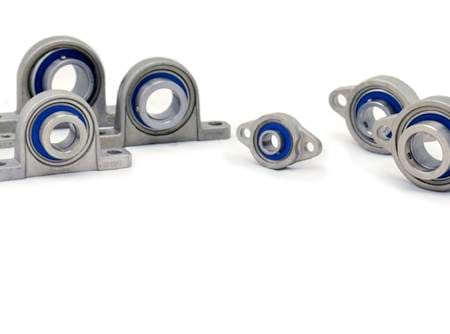  Different types and sizes of mini stainless steel bearings on white background